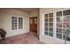Inviting front porch with a decorative wood door, large windows, and tiled flooring at 4941 Bayshore Blvd, Tampa, FL 33611