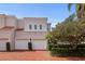 Mediterranean style home featuring a two-car garage, red brick driveway, and well-manicured landscaping at 4941 Bayshore Blvd, Tampa, FL 33611