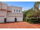 Exterior of home with brick driveway leading to an attached three-car garage at 4941 Bayshore Blvd, Tampa, FL 33611