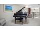 Bright upstairs hall with a black piano and neutral decor at 4941 Bayshore Blvd, Tampa, FL 33611