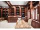 Spacious home office boasts dark wood trim, built-in shelves and cabinetry for ample storage at 4941 Bayshore Blvd, Tampa, FL 33611