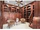 Impressive home office showcasing extensive wood cabinetry, built-in shelves, and cozy seating area at 4941 Bayshore Blvd, Tampa, FL 33611
