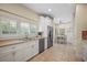 Well-lit kitchen featuring white cabinets, stainless steel appliances, and tile flooring at 4941 Bayshore Blvd, Tampa, FL 33611