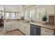 Well-lit kitchen with stainless steel appliances, light cabinets, and a view to the dining area at 4941 Bayshore Blvd, Tampa, FL 33611