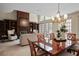 Open-concept living and dining area with a fireplace and views of the pool at 4941 Bayshore Blvd, Tampa, FL 33611