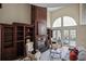 Sunlit living room with a fireplace, custom built-ins, and access to the pool area at 4941 Bayshore Blvd, Tampa, FL 33611