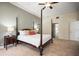 Beautiful main bedroom with a four-poster bed and access to en-suite bathroom at 4941 Bayshore Blvd, Tampa, FL 33611