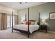 Lovely primary bedroom with a four-poster bed and access to balcony at 4941 Bayshore Blvd, Tampa, FL 33611
