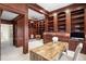 Spacious home office featuring custom wood bookshelves, wainscotting, and built in desk at 4941 Bayshore Blvd, Tampa, FL 33611