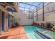 Private screened-in pool offers a tiled deck, and lush landscaping for a relaxing retreat at 4941 Bayshore Blvd, Tampa, FL 33611