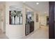 Interior of wet bar with dark cabinetry, granite countertop, mirrored backsplash, and wine cooler at 4941 Bayshore Blvd, Tampa, FL 33611
