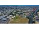 Aerial view of a residential area with canals, tennis courts, and green spaces at 6530 Manila Palm Way, Apollo Beach, FL 33572