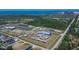 Aerial view showcases sprawling complex with a lake, multiple buildings, and parking at 6530 Manila Palm Way, Apollo Beach, FL 33572
