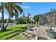The backyard features brick paver patio, lawn, flowering plants, and a view of the waterfront canal at 6530 Manila Palm Way, Apollo Beach, FL 33572