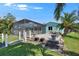 Screened in lanai overlooks the brick paver patio and well-maintained lawn at 6530 Manila Palm Way, Apollo Beach, FL 33572