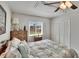 A relaxing bedroom shows a closet, ceiling fan, and a window offering views of the outdoors at 6530 Manila Palm Way, Apollo Beach, FL 33572