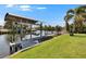 View of boat lift on the canal with tropical plants on the shoreline at 6530 Manila Palm Way, Apollo Beach, FL 33572