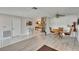 Open dining room and living space with stone fireplace and modern tile flooring at 6530 Manila Palm Way, Apollo Beach, FL 33572