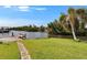 Scenic waterway with private dock, lush greenery, and seating area at 6530 Manila Palm Way, Apollo Beach, FL 33572