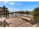 Wooden dock on the canal with bench seating, providing scenic waterfront views at 6530 Manila Palm Way, Apollo Beach, FL 33572