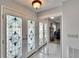 Stained glass double front doors and mirrored closet create a welcoming entryway at 6530 Manila Palm Way, Apollo Beach, FL 33572