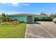 Charming home featuring a unique arched entrance and well-manicured landscaping at 6530 Manila Palm Way, Apollo Beach, FL 33572