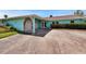 Charming home featuring a unique arched entrance and well-manicured landscaping at 6530 Manila Palm Way, Apollo Beach, FL 33572