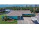 A well-kept waterfront home with a landscaped front yard and a boat in the driveway at 6530 Manila Palm Way, Apollo Beach, FL 33572