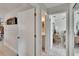 Hallway showing access to a bright bedroom and bathroom, offering a seamless transition between spaces at 6530 Manila Palm Way, Apollo Beach, FL 33572
