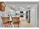 Stylish kitchen featuring breakfast bar, white cabinetry, stainless steel appliances, and easy access to living room at 6530 Manila Palm Way, Apollo Beach, FL 33572