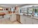 Well-equipped kitchen featuring breakfast bar, stainless steel dishwasher, and open design to billiard room at 6530 Manila Palm Way, Apollo Beach, FL 33572