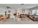 Open living and dining area with ceiling fan, wood-look floors, and bright natural light at 6530 Manila Palm Way, Apollo Beach, FL 33572