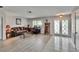 Bright living room features wood-look floors, elegant furniture, and decorative front doors at 6530 Manila Palm Way, Apollo Beach, FL 33572