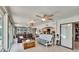 Bright and airy living room featuring wood floors, neutral walls, and access to kitchen and outdoor pool at 6530 Manila Palm Way, Apollo Beach, FL 33572