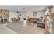 Open-concept living and dining area with stone fireplace and wood-look floors at 6530 Manila Palm Way, Apollo Beach, FL 33572
