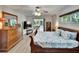 Comfortable main bedroom with wood-look floors and sliding door access to the lanai at 6530 Manila Palm Way, Apollo Beach, FL 33572