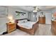 Bright main bedroom with wood-look floors, ceiling fan, and neutral paint at 6530 Manila Palm Way, Apollo Beach, FL 33572
