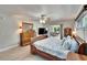 Comfortable main bedroom with wood-look floors and sliding door access to the lanai at 6530 Manila Palm Way, Apollo Beach, FL 33572