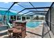 Relax in this large screened pool area featuring an outdoor tiki bar and clear pool waters at 6530 Manila Palm Way, Apollo Beach, FL 33572