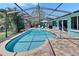 Amazing screened pool with brick pavers, outdoor lounging, and lush tropical landscaping at 6530 Manila Palm Way, Apollo Beach, FL 33572