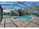 Relax in this pristine screened in pool with beautiful water views and outdoor seating at 6530 Manila Palm Way, Apollo Beach, FL 33572
