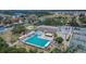 Aerial view of a community pool and tennis courts surrounded by lush landscaping at 6530 Manila Palm Way, Apollo Beach, FL 33572