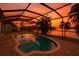 Enclosed pool featuring a stunning sunset view over the water at 6530 Manila Palm Way, Apollo Beach, FL 33572