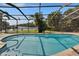 Sparkling pool with waterfront views and a serene screened-in enclosure at 6530 Manila Palm Way, Apollo Beach, FL 33572
