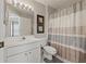 Neat bathroom features vanity, framed art, and a tub shower with striped curtain at 6623 Northhaven Ct, Riverview, FL 33578