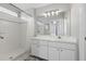 Bright bathroom features a walk-in shower, white vanity, and a large mirror with modern lighting at 6623 Northhaven Ct, Riverview, FL 33578