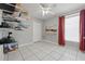 Bedroom with white walls, red curtains and ceiling fan at 6623 Northhaven Ct, Riverview, FL 33578