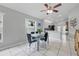 Bright dining area with white tile, view of kitchen, and a modern glass table with seating for four at 6623 Northhaven Ct, Riverview, FL 33578