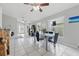 Bright dining area with a glass-top table and views into the spacious living room, ideal for entertaining guests at 6623 Northhaven Ct, Riverview, FL 33578