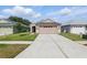 Exterior view of a well-maintained home with a two-car garage and landscaped front yard at 6623 Northhaven Ct, Riverview, FL 33578